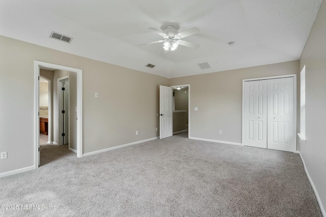 unfurnished bedroom featuring carpet floors, baseboards, and visible vents