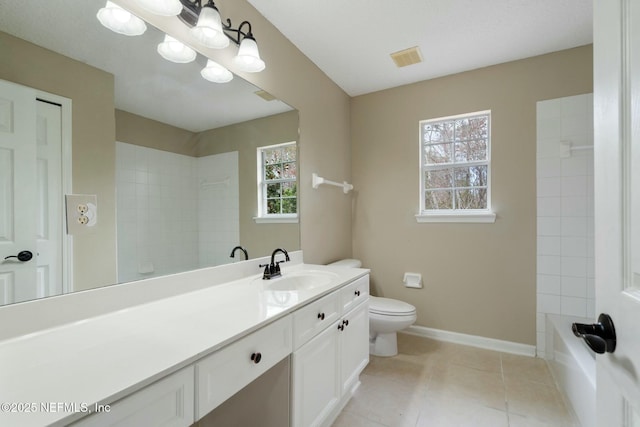 bathroom featuring toilet, visible vents, vanity, baseboards, and tile patterned floors