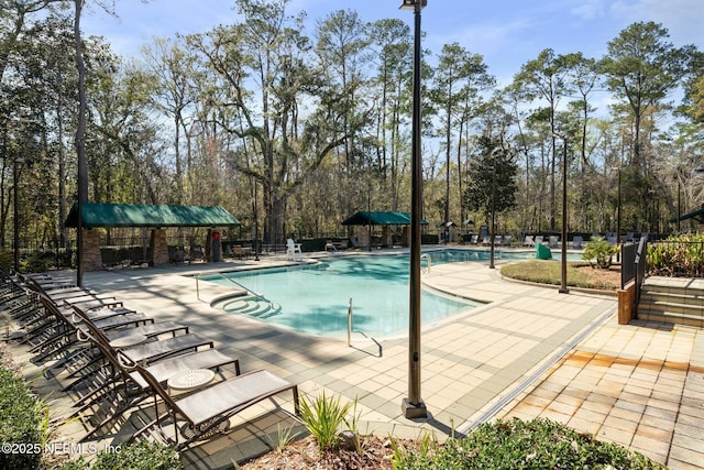 pool with a patio and fence