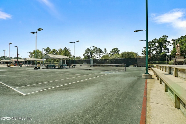 view of tennis court featuring fence