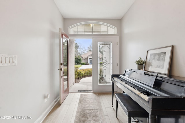 entryway with light wood-style flooring and baseboards