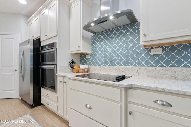 kitchen with tasteful backsplash, ventilation hood, light wood-style floors, appliances with stainless steel finishes, and white cabinets