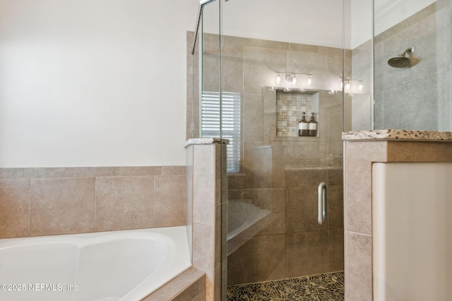 full bath with a shower stall and a garden tub