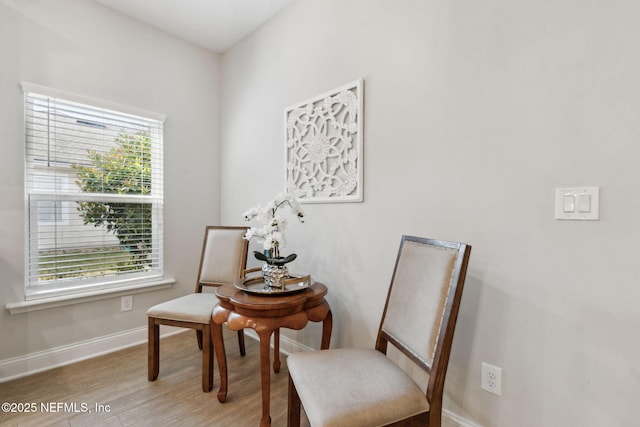 living area with wood finished floors and baseboards