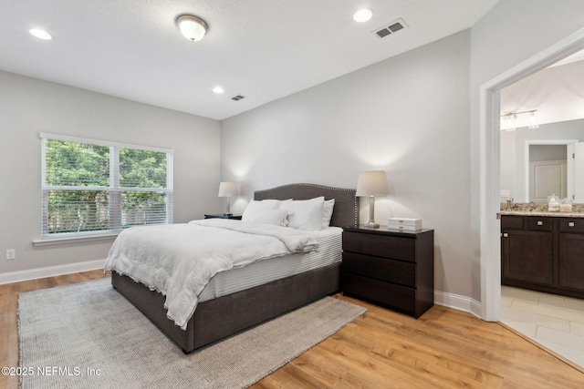 bedroom with recessed lighting, visible vents, light wood-style flooring, and baseboards