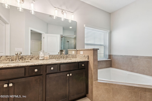 bathroom with a sink, double vanity, a bath, and a shower stall