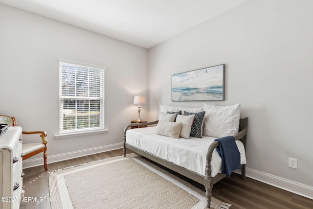 bedroom featuring baseboards and wood finished floors