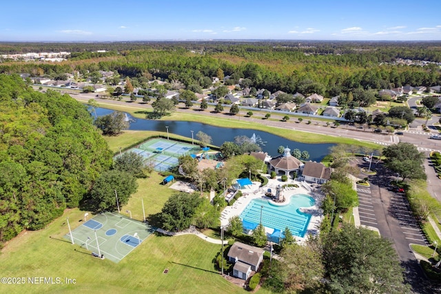 aerial view featuring a wooded view and a water view