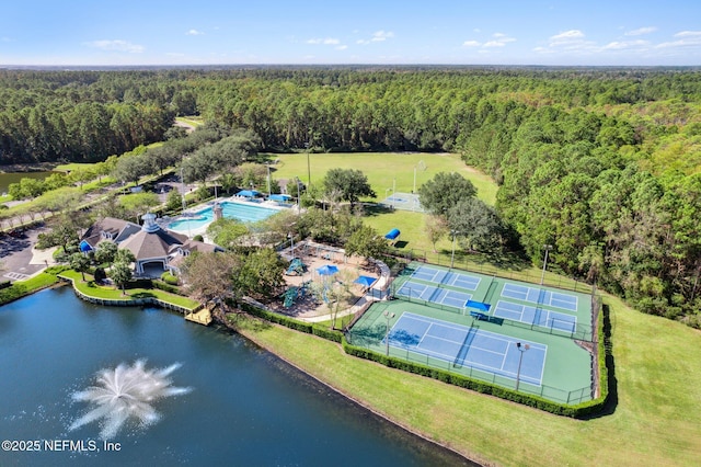 drone / aerial view with a view of trees and a water view