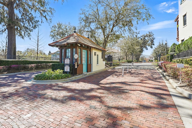 view of property's community with fence and a gate