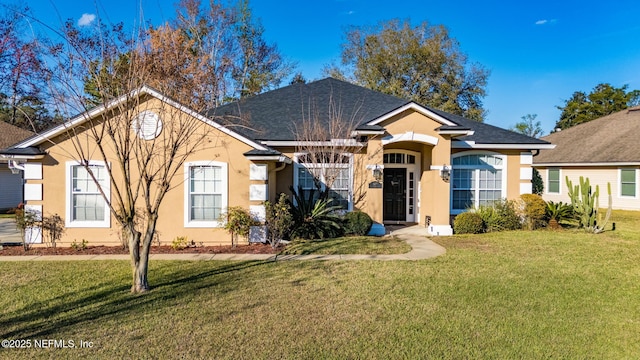 single story home with a shingled roof, a front yard, and stucco siding