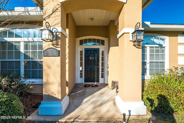 property entrance with stucco siding