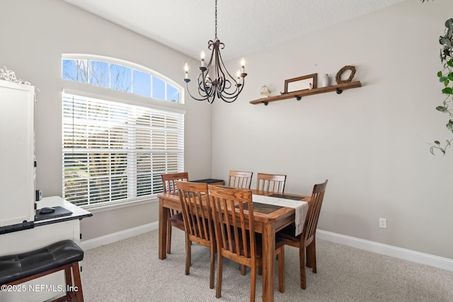 dining room with carpet floors, a wealth of natural light, and baseboards