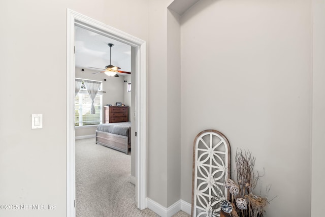 hall featuring carpet floors and baseboards