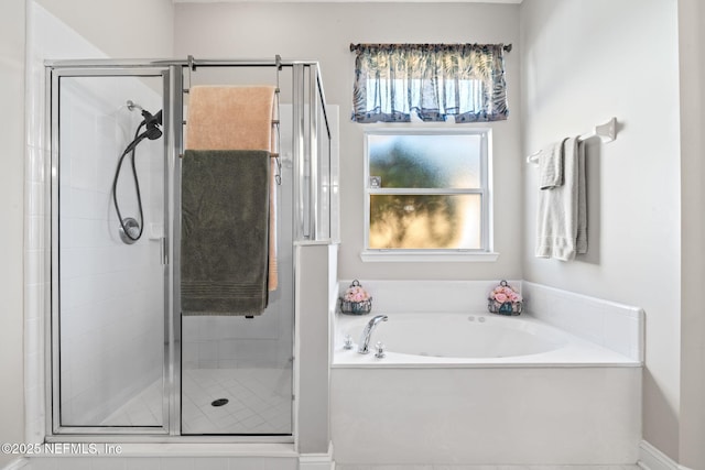 full bathroom featuring a garden tub and a shower stall