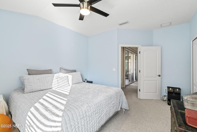 bedroom featuring lofted ceiling, light colored carpet, ceiling fan, and visible vents