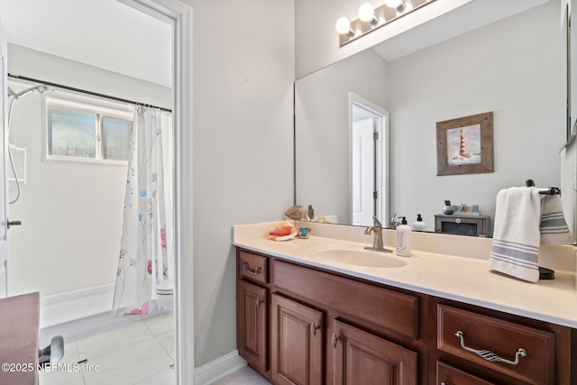 full bath with a shower with curtain, vanity, and tile patterned floors