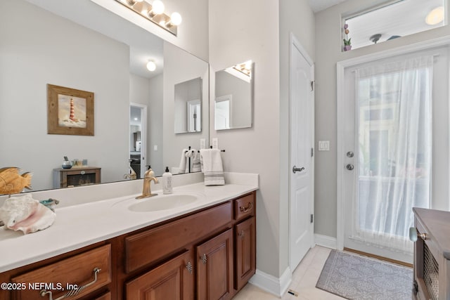 bathroom featuring tile patterned flooring, baseboards, and vanity