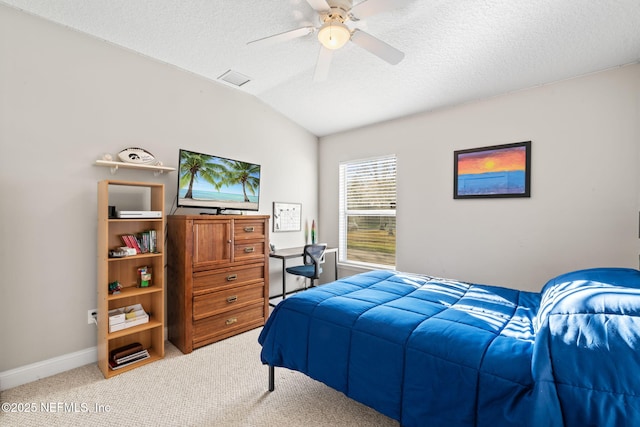 bedroom featuring lofted ceiling, baseboards, a textured ceiling, and light colored carpet