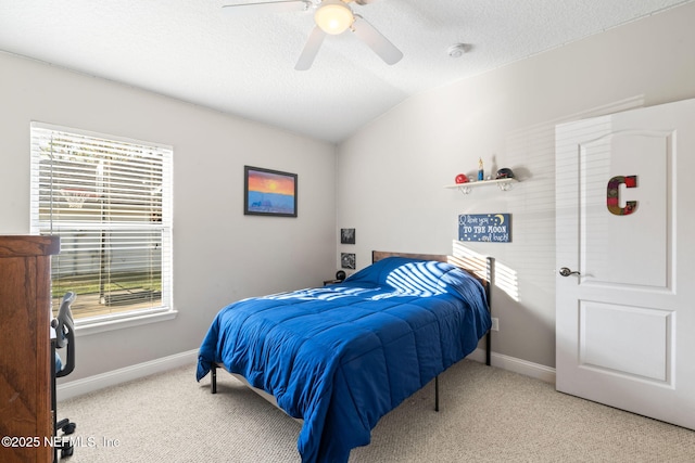 bedroom with a textured ceiling, baseboards, vaulted ceiling, and carpet flooring