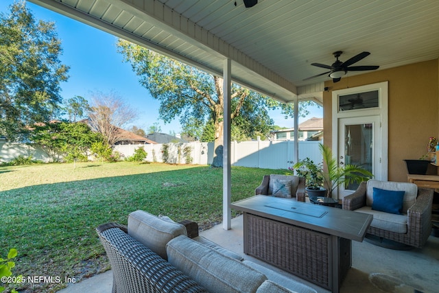 view of patio / terrace featuring a fenced backyard, an outdoor living space, and a ceiling fan