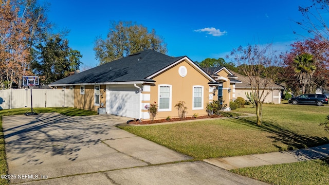 ranch-style home featuring concrete driveway, an attached garage, fence, a front yard, and stucco siding