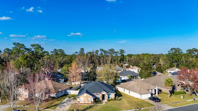 birds eye view of property with a residential view and a wooded view