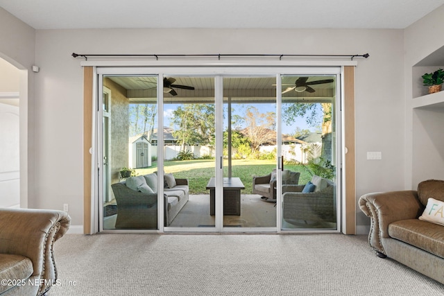 entryway featuring carpet floors, ceiling fan, and baseboards