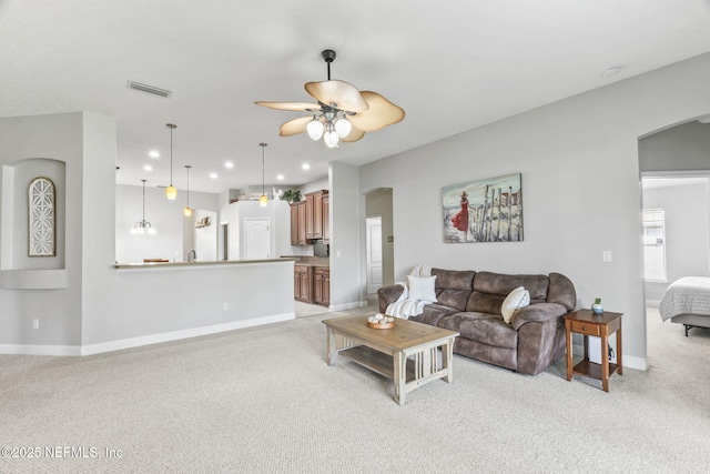 3077 Five Oaks Ln, Green Cove Springs, FL 32043 - living room featuring arched walkways, light colored carpet, baseboards, a ceiling fan, and recessed lighting