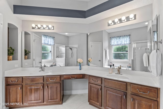 3077 Five Oaks Ln, Green Cove Springs, FL 32043 - bathroom featuring a shower stall, healthy amount of natural light, double vanity, and tile patterned flooring