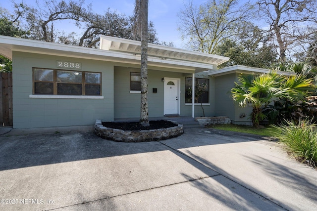 view of front of property featuring concrete block siding