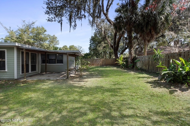 view of yard with a patio area and a fenced backyard