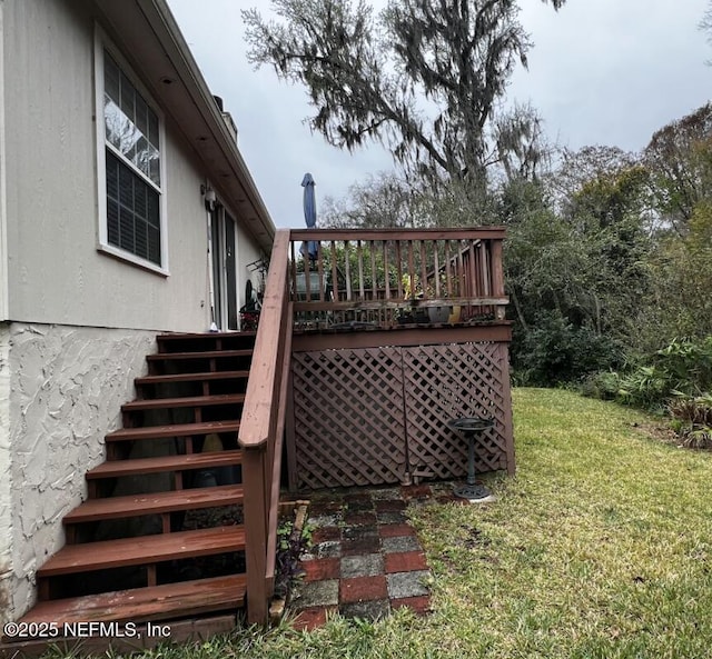 view of yard with a deck and stairway