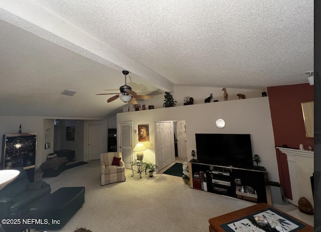 carpeted living room with vaulted ceiling with beams, a fireplace, a textured ceiling, and a ceiling fan