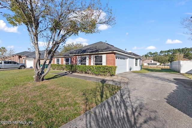 single story home featuring a garage, brick siding, fence, driveway, and a front yard