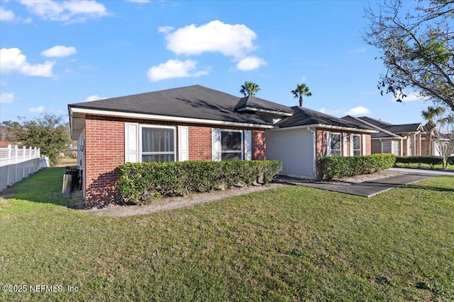 ranch-style house with brick siding, fence, and a front lawn