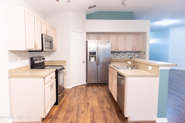 kitchen featuring an island with sink, appliances with stainless steel finishes, dark wood-type flooring, and a sink