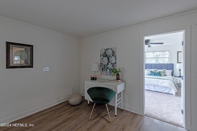 office with a textured ceiling, baseboards, and wood finished floors