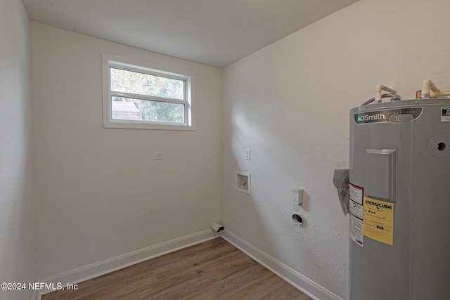 laundry area featuring hookup for a washing machine, electric water heater, electric dryer hookup, laundry area, and baseboards