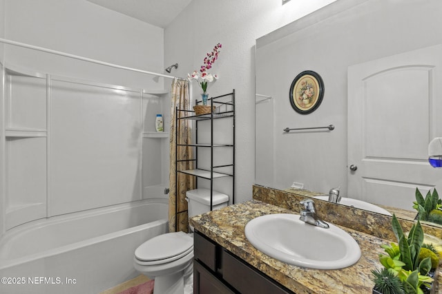 full bathroom featuring toilet, a textured wall, vanity, and bathing tub / shower combination