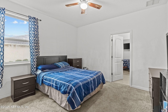 bedroom featuring baseboards, ceiling fan, visible vents, and light colored carpet