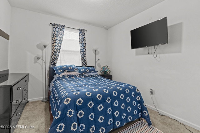 carpeted bedroom with baseboards and a textured ceiling