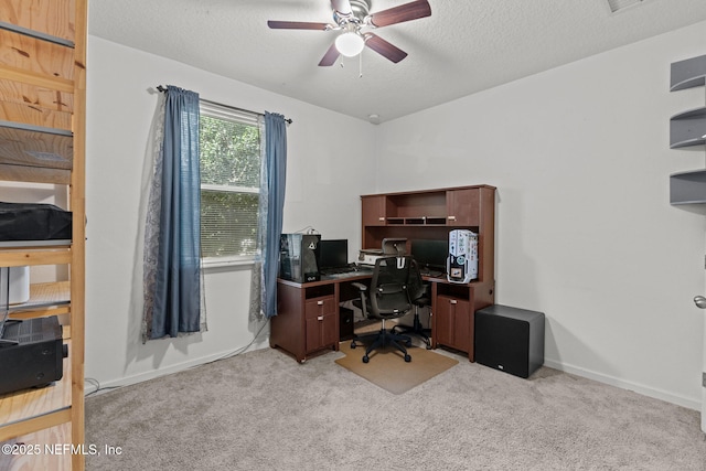 office with a textured ceiling, baseboards, and light colored carpet