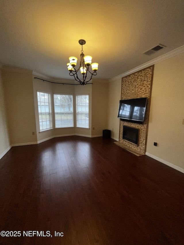 unfurnished living room featuring a fireplace, dark wood finished floors, visible vents, and crown molding