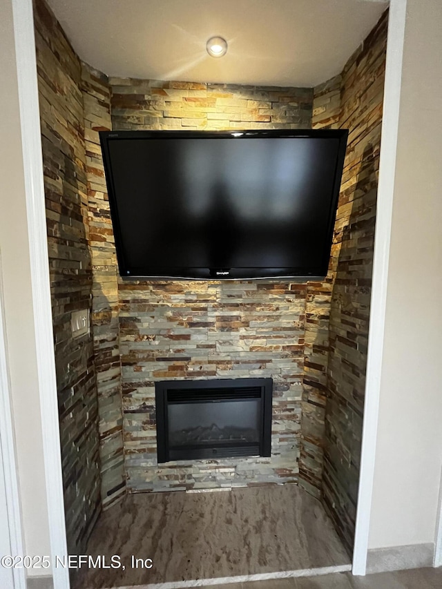 interior details featuring a glass covered fireplace