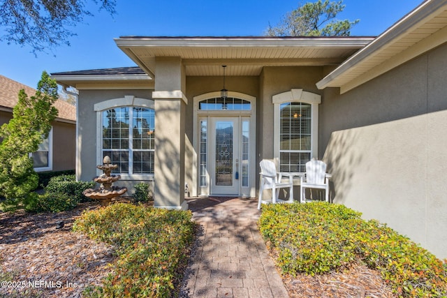 entrance to property with stucco siding