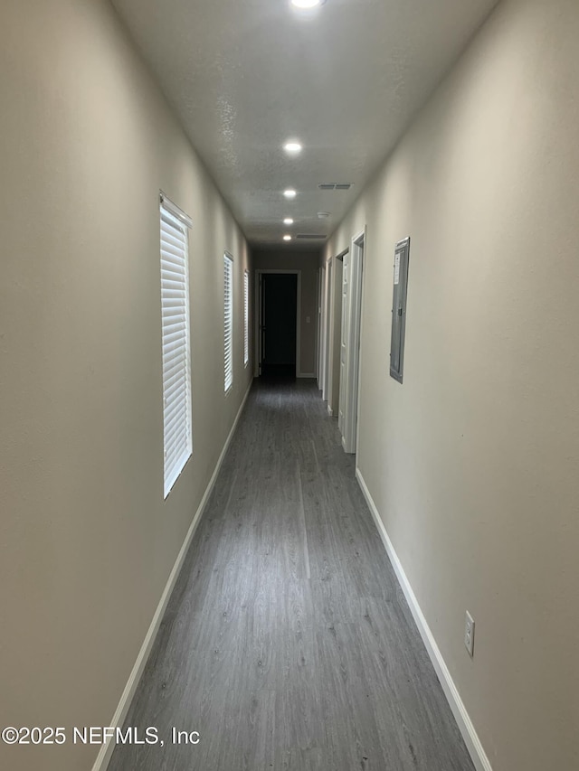 hallway with baseboards and wood finished floors