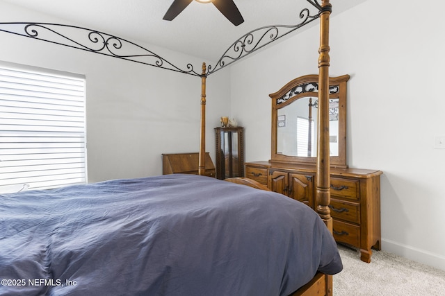 bedroom with ceiling fan, multiple windows, and light colored carpet