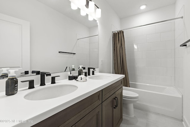 bathroom with double vanity, shower / tub combo, a sink, and toilet