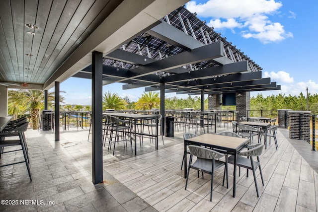 view of patio featuring outdoor dining area and a pergola